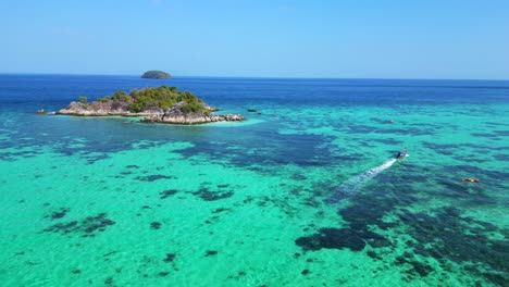 boat-beach-rocky-cliff-island-turquoise-blue-sea