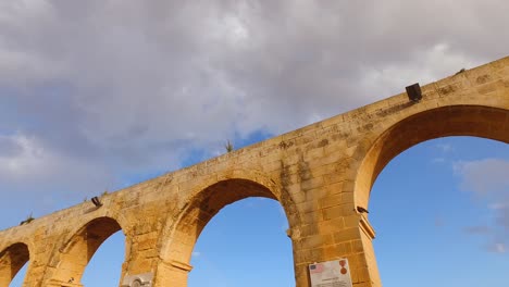 Arches-of-the-Upper-Barrakka-Gardens-on-the-background-of-the-blue-sky-with-white-clouds,-low-angle-dolly-shot