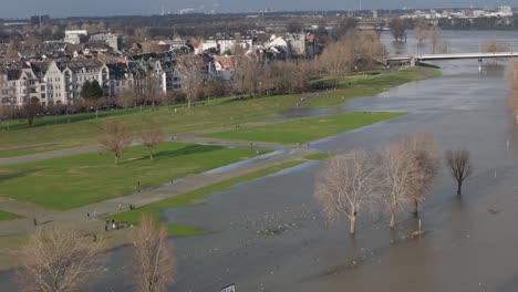Right-Panning-Shot-of-Flooding-Park-by-Residential-Houses,-Germany,-Daytime