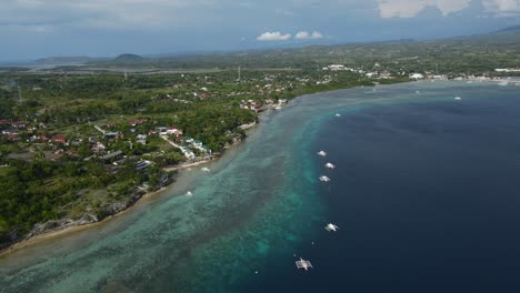 Cebu-Island-Phillipines-Aerial-Panoramic-Landscape-of-Blue-Pristine-Beach-and-Green-Tropical-Coastline