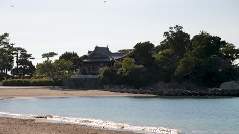 Calm-scenery-at-wide-open-beach-with-Japanese-shrine-in-distance