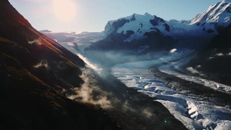 A-breathtaking-sunny-view-of-a-mountainous-glacier-landscape-with-mist-rising-in-the-valleys