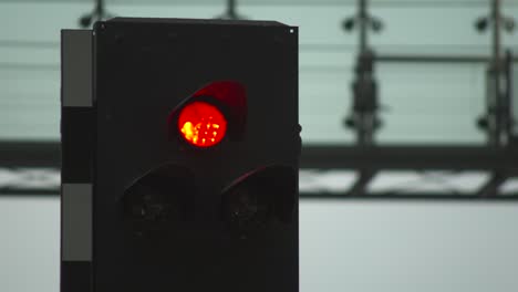 Green-traffic-light-with-blurred-background,-signaling-go,-changing-to-red-and-yellow
