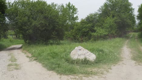 Drone-approaching-a-natural-rock-landmark-in-a-low-altitude-in-the-woodlands-of-Tsarichina-Hole,-a-place-in-Bulgaria-known-for-some-paranormal-activities