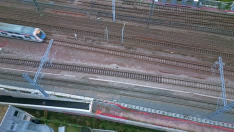 Train-running-on-railway.-Aerial-top-down-sideways