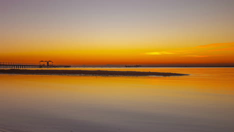 Bright-yellow-sunrise-over-calm-seascape,-time-lapse