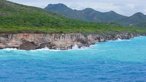 Telephoto-aerial-parallax-of-Caribbean-sea-cliffs-battered-by-ocean-waves-crashing-in-strong-storm-swell