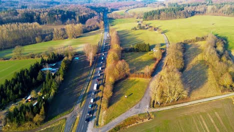 Aerial-View-of-a-Serene-Country-Road-Flanked-by-Lush-Fields-and-Trees
