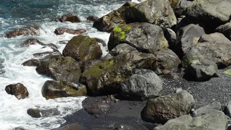 Atlantic-ocean-waves-flow-over-rocks-in-Tenerife-island,-handheld-view