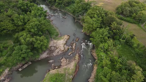 aerial-view,-river-flow-squeezed-by-tropical-forest