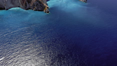 Aerial:-Reveal-shot-of-Navagio-beach-in-Zakynthos-with-the-famous-wrecked-ship-on-a-sunny-day