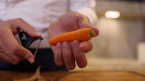 Chef-Peeling-Carrot.-Low-Angle-Shot