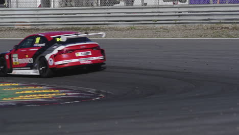 Race-car-has-oversteer-when-taking-a-turn,-sliding-in-corner-and-burning-rubber