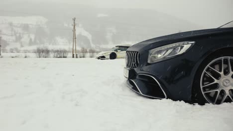 Luxury-sports-car-drive-on-snowy-race-track-during-blizzard,-drift-event