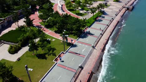 Picturesque-aerial-descending-view-of-Weihai-Xingfu-park-seaside-promenade