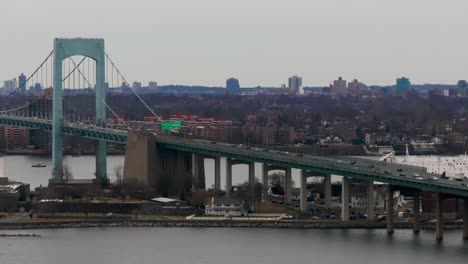 An-aerial-view-of-the-Throgs-Neck-Bridge-from-over-the-Long-Island-Sound,-NY-on-a-cloudy-day