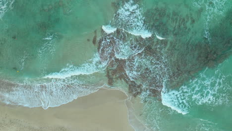 Aerial-top-down-shot-of-waves-reaching-beach-in-Cyprus