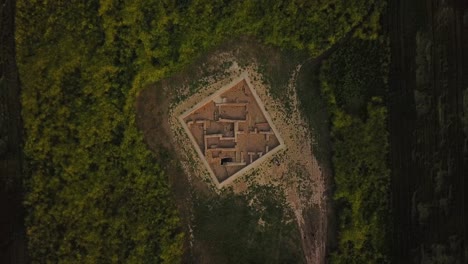 rotate-Birdseye-view-on-historical-ancient-archaeological-sites-in-middle-of-farm-field-agriculture-land-in-Dezful-the-traditional-mud-brick-ruins-of-clay-building-plan-architectural-design-in-Iran