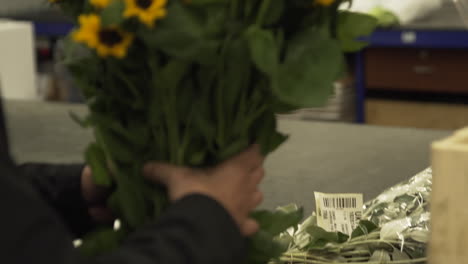 Woman-Picks-Up-Bunch-of-Roses-and-Puts-Them-In-a-Box