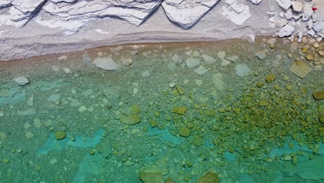 Aerial-top-view-over-the-crystal-clear-water-of-the-Georgian-Bay,-with-a-rocky-coastline,-Ontario,-Canada