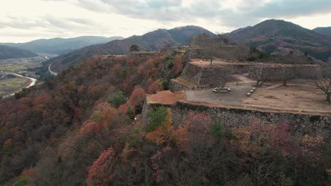 Japanese-Mountain-Range-and-Ancient-Castle-Ruins-in-Takeda,-Hyogo,-Natural-Landscape-of-Countryside-in-Asia-Aerial-Drone-Shot