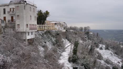 View-of-buildings-and-streets-of-Guardiagrele-under-snow-in-winter,-Abruzzo,-Italy