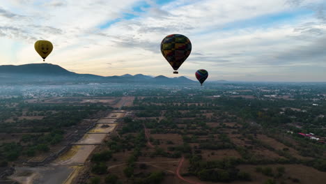 Drone-shot-toward-a-hot-air-balloon-on-the-countryside,-sunny-morning-in-Mexico