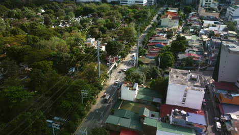 Drone-shot-overlooking-traffic-on-the-south-Avenue,-in-sunny-Makati,-Philippines