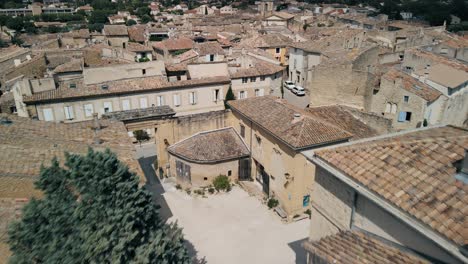 Lauris-France-weathered-grey-brown-rooftops-in-the-countryside,-aerial-dolly