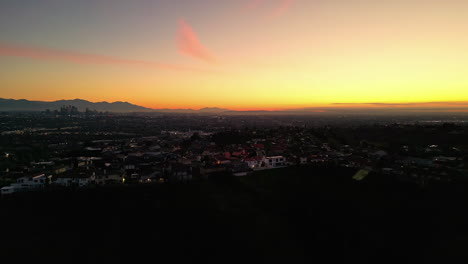 Aerial-View-Across-Los-Angeles-with-Evening-Orange-Sunset-Skies,-USA