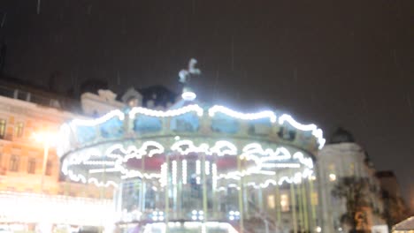 KIEV,-UKRAINE---DECEMBER-27,-2019:-Festive-carousel-is-spinning-with-people-on-New-Year-blurred