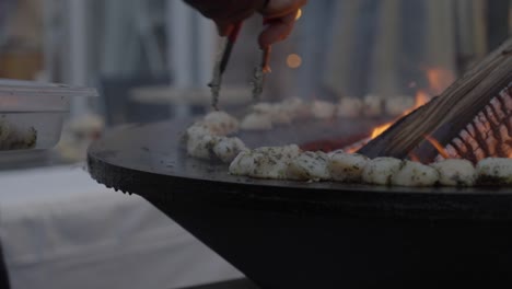 Slow-motion-shot-of-raw-food-being-cooked-on-a-open-fireplace