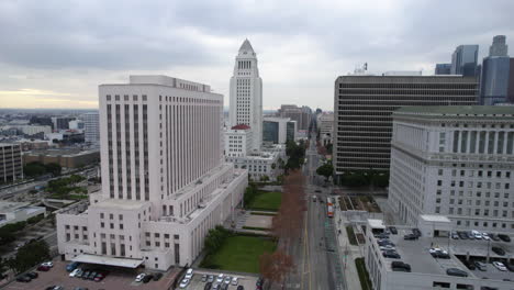 Drone-Shot-of-Los-Angeles-City-Hall,-Spring-Street-Courthouse-LA-Superior-Court,-Hall-of-Justice-and-Downtown-Traffic