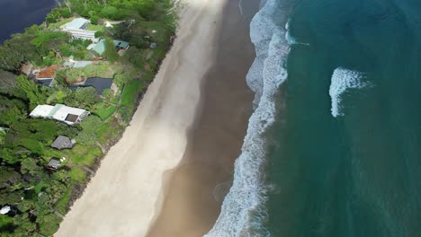 Vista-Aérea-Sobre-La-Costa-Arenosa-De-La-Playa-De-Pertenencia-En-Byron-Bay,-Nsw,-Australia---Disparo-De-Drone