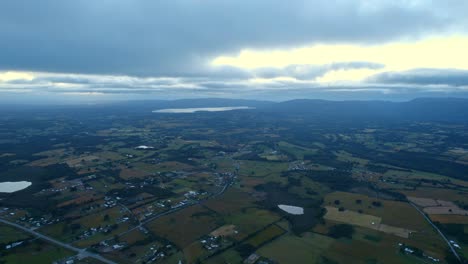 View-from-above-of-a-rural-setting-at-sunset-on-the-big-island-of-Chiloé,-Chile