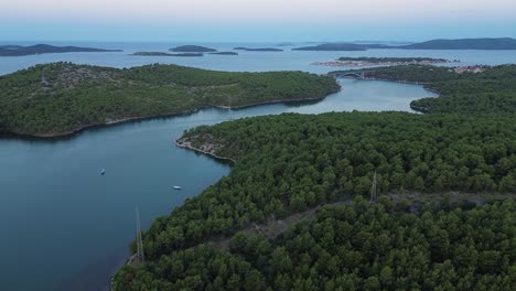 Aerial-View-of-Greek-Coastline:-Forested-Shoreline-with-Island,boats-and-Bridge