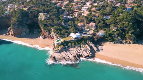 Aerial-views-of-luxurious-house-with-sea-views,-on-a-cliff-on-the-beach-of-Pals-Begur-Costa-Brava