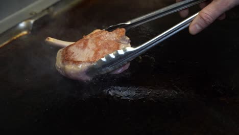 Cooking-a-slice-of-meat-on-a-cooking-stove-at-a-restaurant