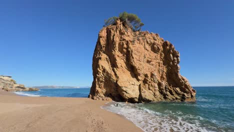 Red-island-beach-in-Pals,-Costa-Brava,-rock-in-the-middle-of-the-Mediterranean-Sea,-blue,-turquoise,-beach,-nudist,-naturist-luxury-tourism