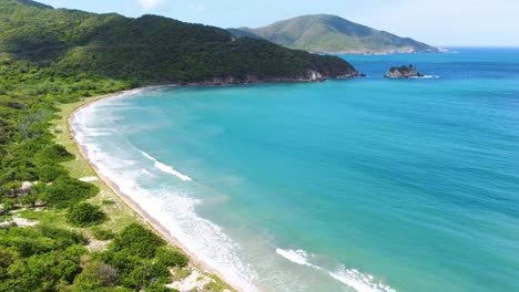 Annähernde-Drohne,-Aufgenommen-über-Einem-Strand-Im-Tayrona-Nationalpark,-Am-Fuße-Der-Sierra-Nevada-De-Santa-Marta,-Dem-Höchsten-Küstenberg-Der-Welt-In-Kolumbien,-Südamerika