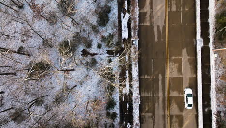 Mount-sequoyah-with-trees-dusted-in-snow,-urban-edge-visible,-winter-setting,-aerial-view