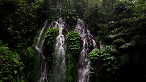 Banyu-Wana-Amertha-pristine-waterfall-flowing-in-lush-jungle,-Bali-in-Indonesia
