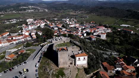 Historic-Belmonte-Castle-Overlooking-Portuguese-Village---aerial-overhead-reveal