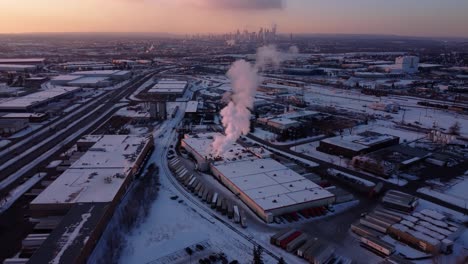 A-revealing-shot-of-the-steaming-factory-and-Calgary-Downtown