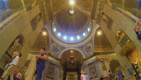 Indoors-view-on-dome-of-Saint-Peters-Basilica-wide-low-angle-with-visitors