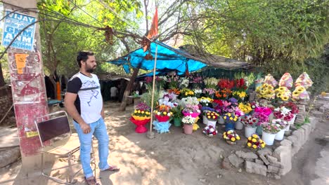 An-Indian-male-florist-standing-next-to-his-roadside-stall-of-a-colorful-flower-shop-near-Sikanderpur-Bristol-Hotel