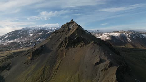 Aerial-view-of-an-icelandic-mountain-peak,-cloudy-day,-alpine-view