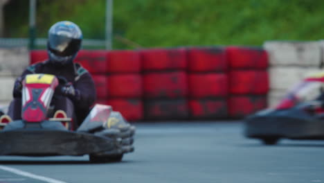 Kart-drivers-coming-out-of-turn-maintaining-speed-in-ideal-race-line