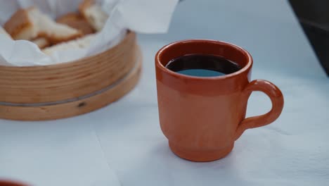 Rustic-Terracotta-Cup-with-Red-Wine-and-Bread