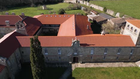 Drone-descends-tilting-up-along-entrance-of-San-Salvador-de-Ferreira-monastery